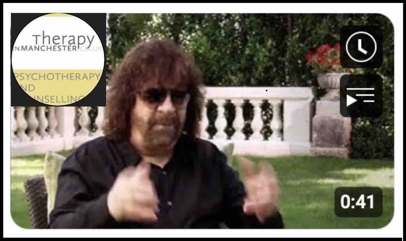 Musician Jeff Lynne in garden with white balustrade behind